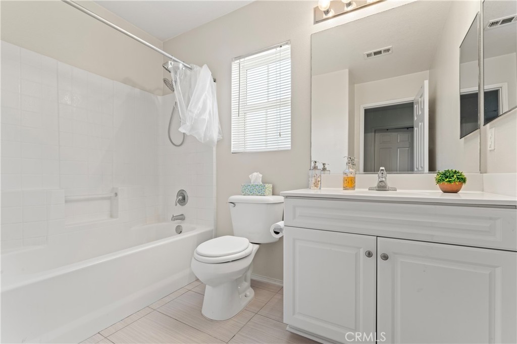 1339 Castledale Street Riverside, CA 92501 - Photo 21 of 27 a bathroom with a sink a toilet and shower