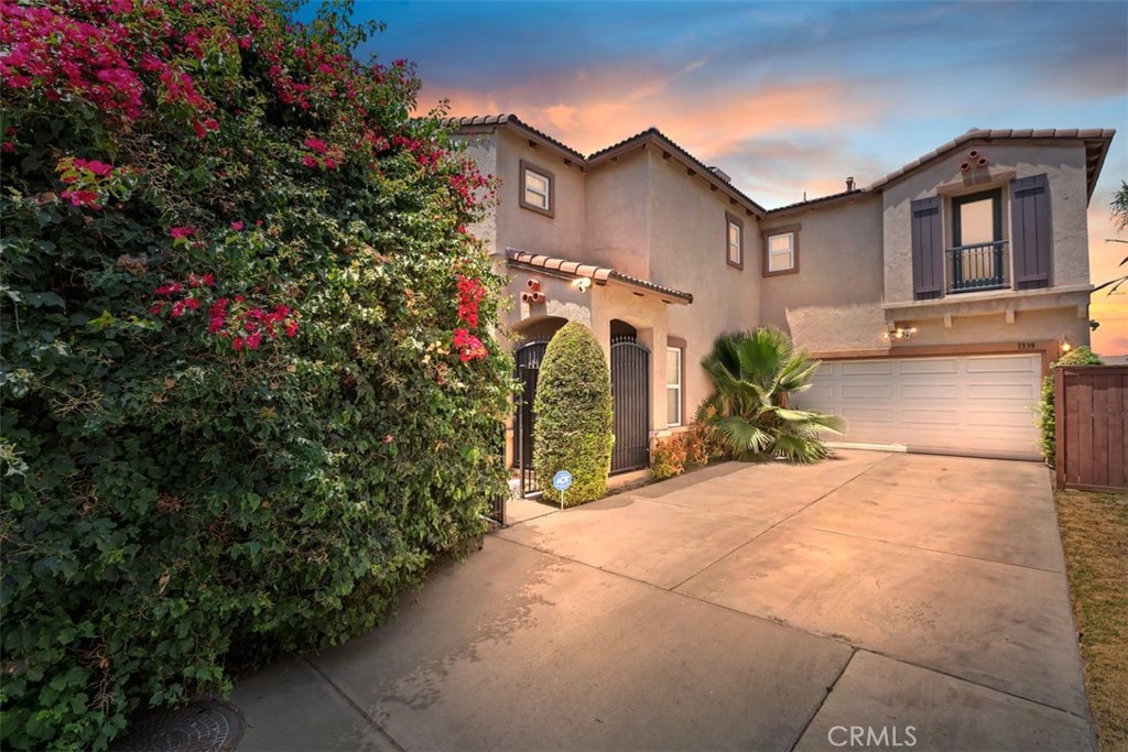 1339 Castledale Street Riverside, CA 92501 - Photo 3 of 27 a view of a house with a small yard and potted plants