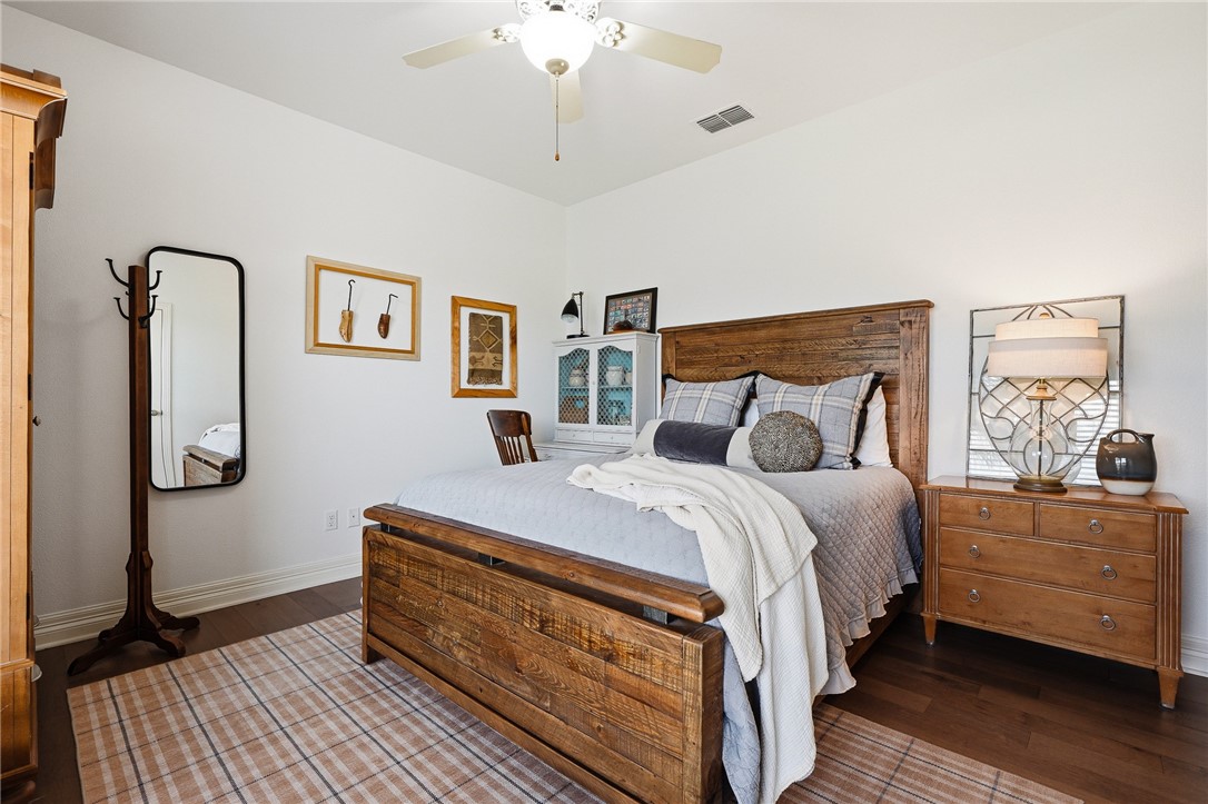 8710 KIng Ranch Drive Corpus Christi, TX 78414 - Photo 17 of 38 a bed room with a bed and a chandelier