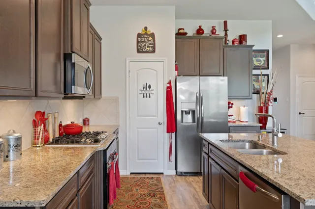 a kitchen with refrigerator and cabinets