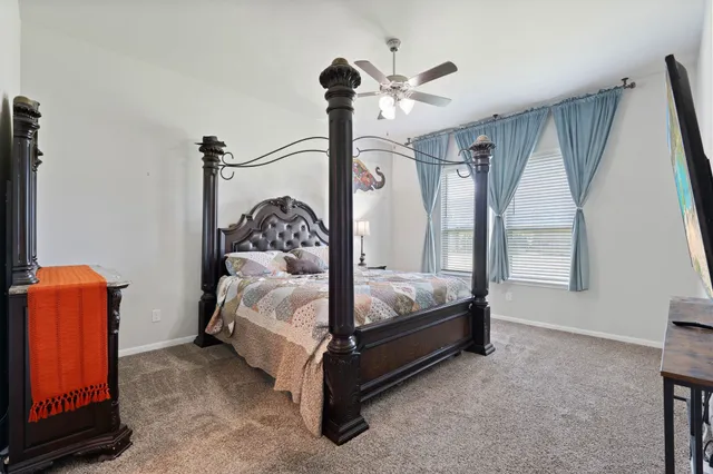 a bedroom with a bed and a tv on the dresser
