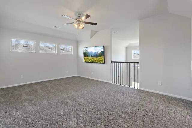 a view of entryway and hall with a chandelier fan