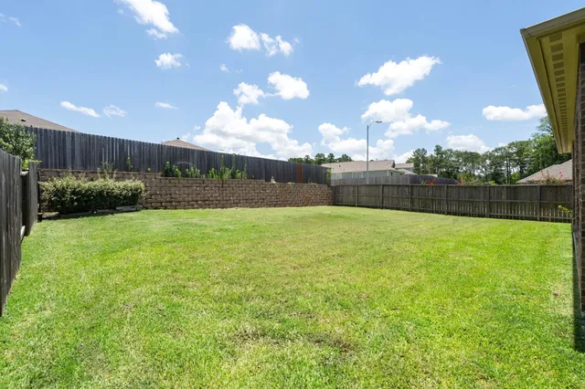 a view of yard with swimming pool and green space