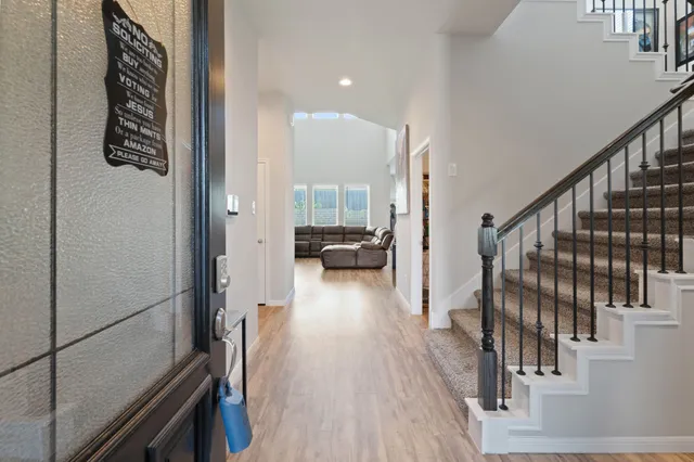 a view of hallway with wooden floor