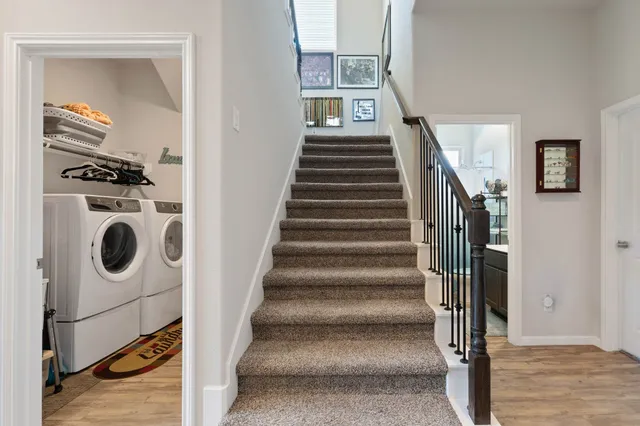 a view of entryway and hall with wooden floor