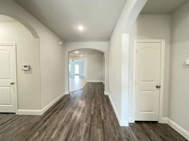 a view of a hallway with wooden floor