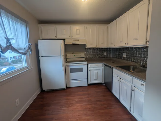 a kitchen with a white cabinets and white appliances