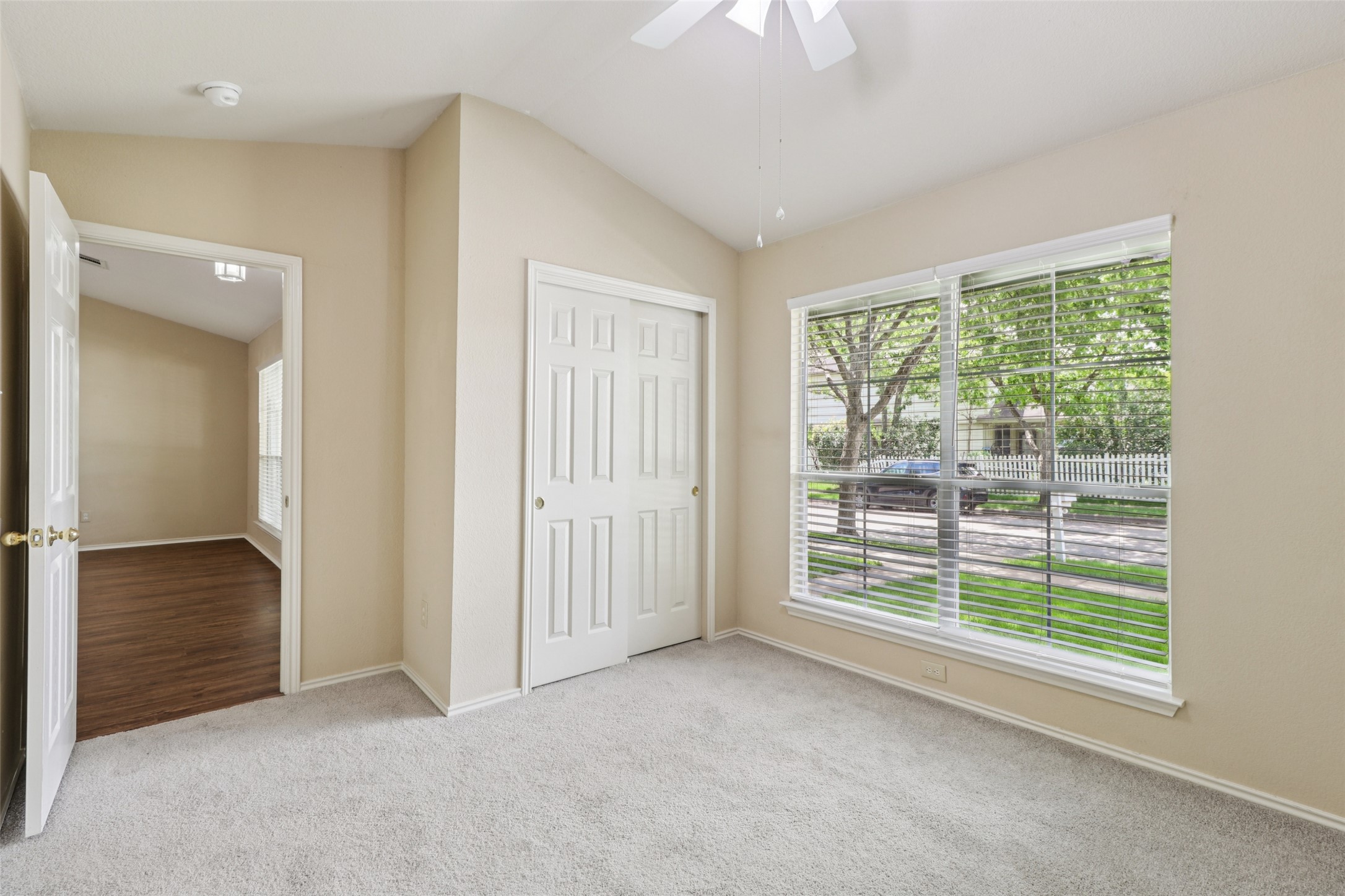 700 Scheel Road Kyle, TX 78640 - Photo 27 of 39 The property features a room with vaulted ceilings, light-colored walls, and carpet flooring