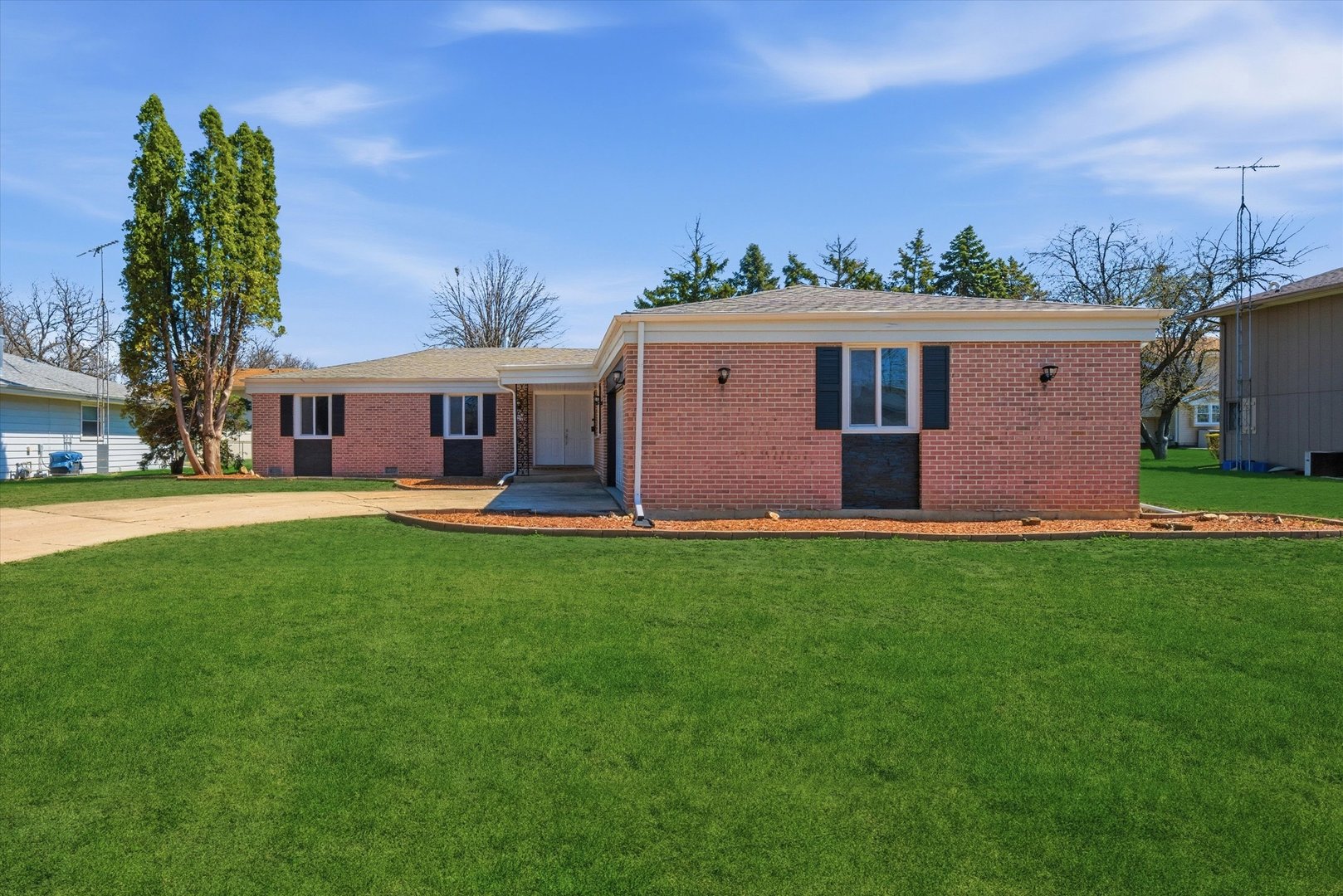 a front view of house with yard and green space