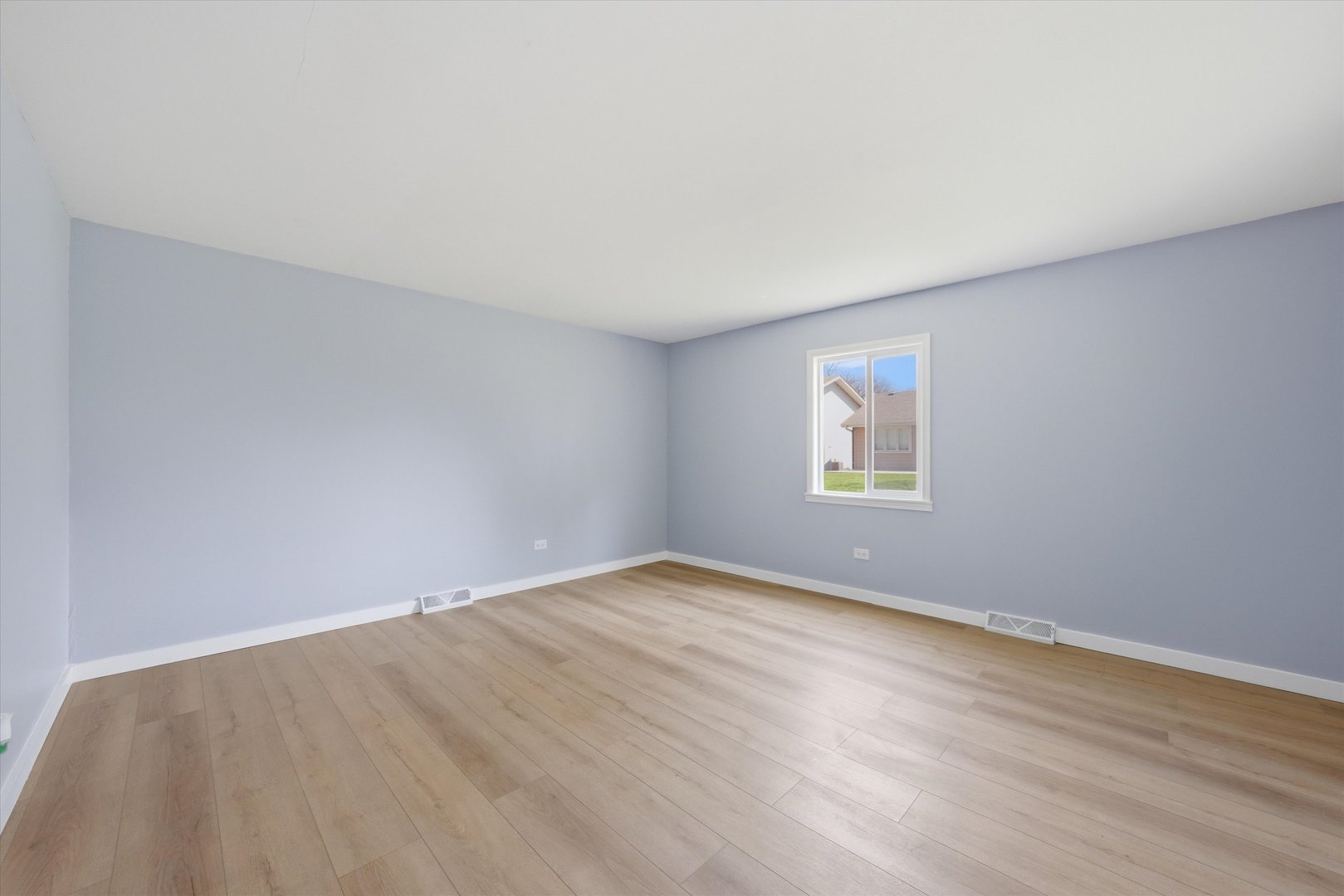 518 Apollo Drive Joliet, IL 60435 - Photo 19 of 25 a view of an empty room with wooden floor and a window