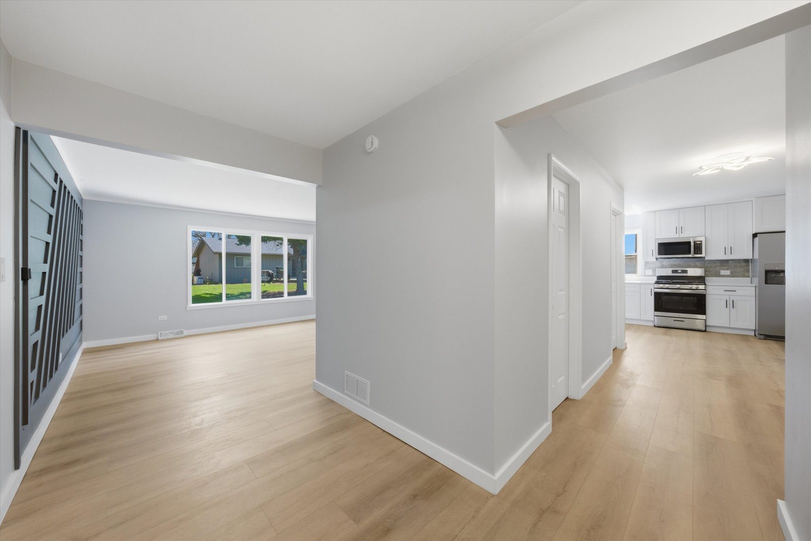 518 Apollo Drive Joliet, IL 60435 - Photo 5 of 25 a view of a kitchen with wooden floor and windows