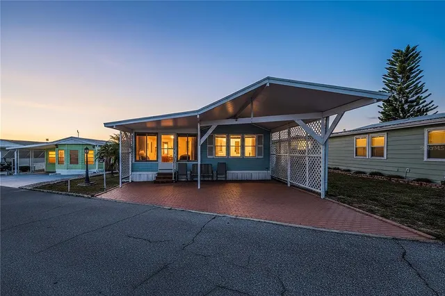 a view of a house with backyard and porch