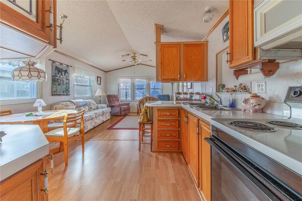 251 Patterson Road, Unit F22 Haines City, FL 33844 - Photo 12 of 50 a kitchen with stainless steel appliances granite countertop sink stove top oven and cabinets