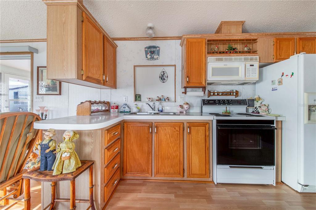 251 Patterson Road, Unit F22 Haines City, FL 33844 - Photo 14 of 50 a kitchen with stainless steel appliances granite countertop a refrigerator and a stove top oven