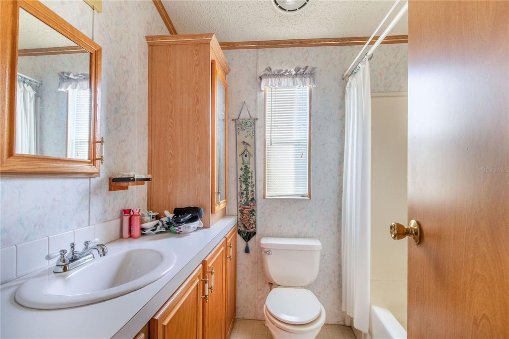 251 Patterson Road, Unit F22 Haines City, FL 33844 - Photo 15 of 50 a bathroom with a sink a toilet and shower