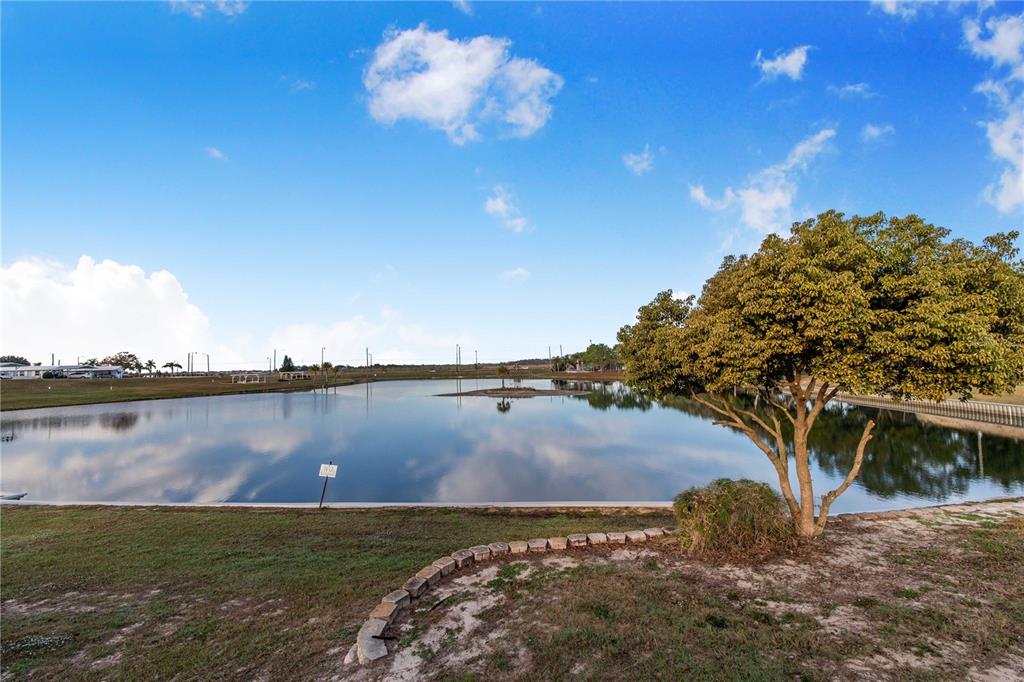 251 Patterson Road, Unit F22 Haines City, FL 33844 - Photo 38 of 50 a view of a lake with a mountain in the background