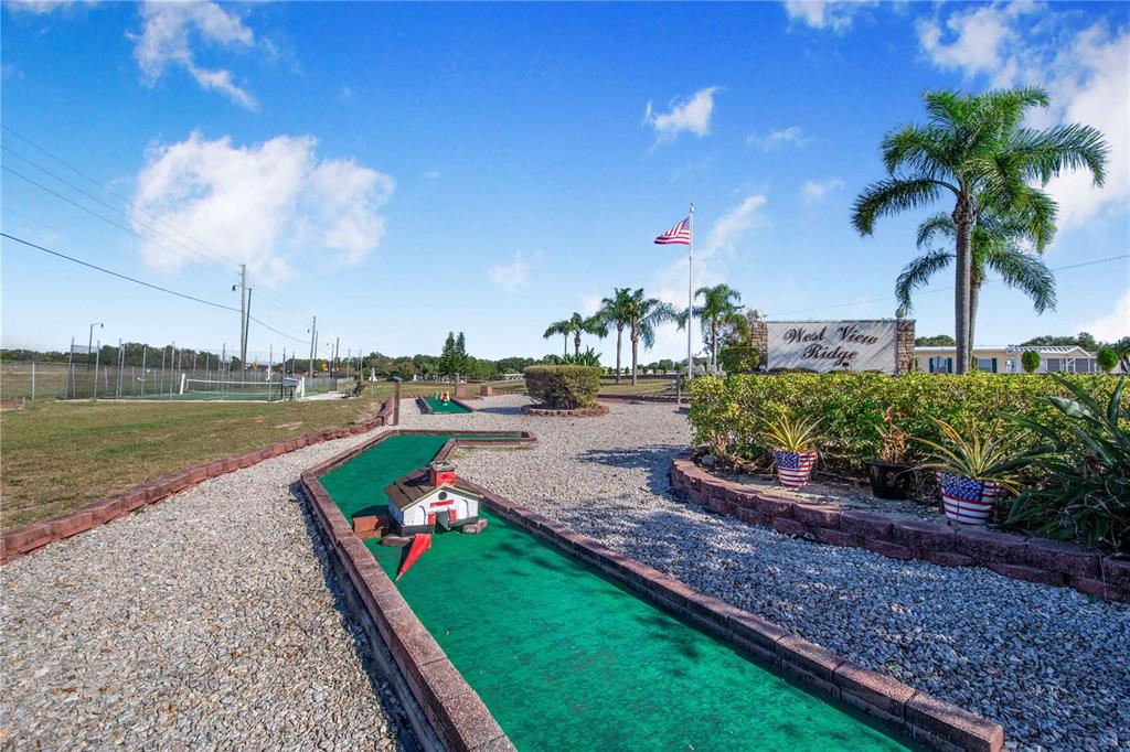 251 Patterson Road, Unit F22 Haines City, FL 33844 - Photo 46 of 50 a view of a garden with a lake