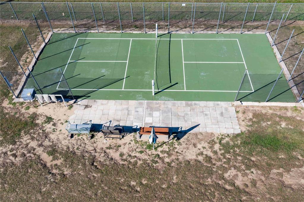 251 Patterson Road, Unit F22 Haines City, FL 33844 - Photo 47 of 50 a view of a tennis ground with large trees