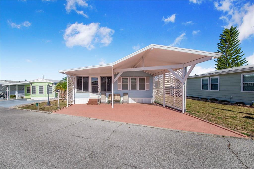 251 Patterson Road, Unit F22 Haines City, FL 33844 - Photo 5 of 50 a patio with a table and chairs and potted plants