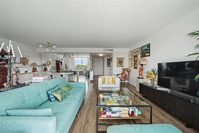 a living room with furniture and a kitchen view