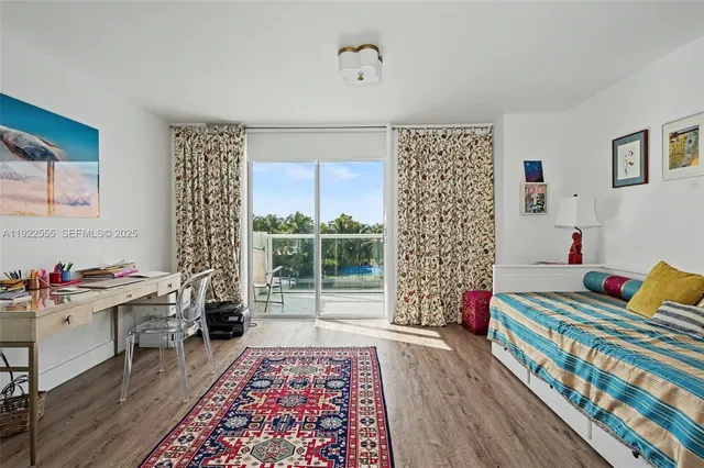 a bedroom with furniture and wooden floor