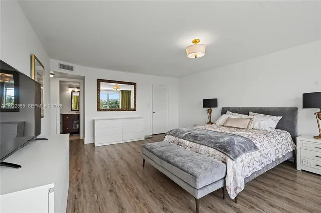 a bedroom with a bed and large window