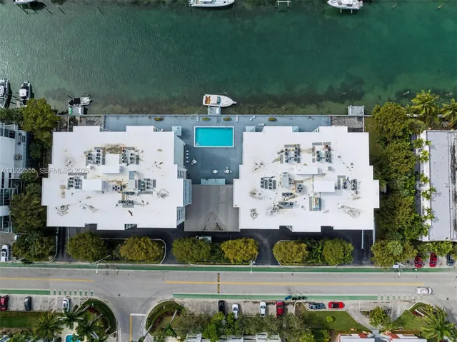 an aerial view of a house with a yard