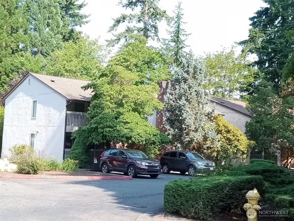 a front view of a house with a garden and plants