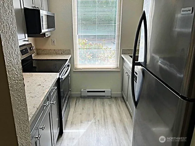 a kitchen with a refrigerator and a sink