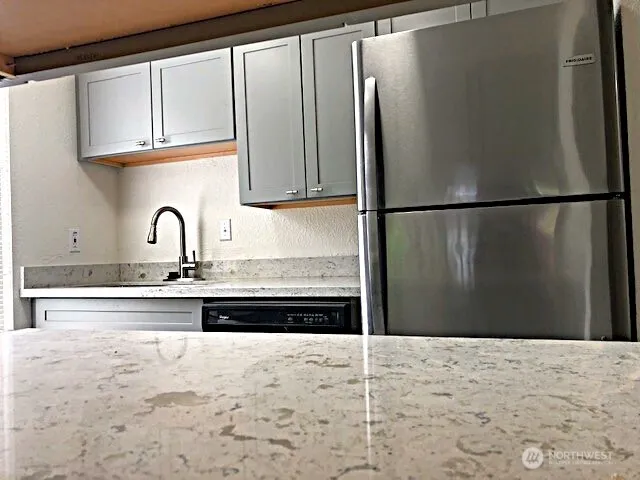 a kitchen with a refrigerator and a sink