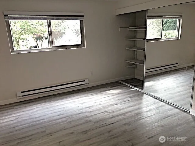 a view of a room with wooden floor and windows