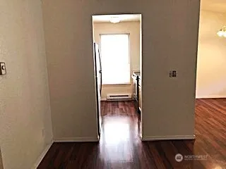 a view of a room with wooden floor and a window