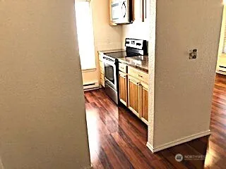 a kitchen with stainless steel appliances granite countertop a stove and a refrigerator