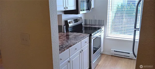 a kitchen with stainless steel appliances granite countertop a sink and a stove