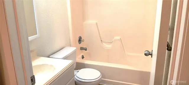 a bathroom with a toilet and a shower curtain