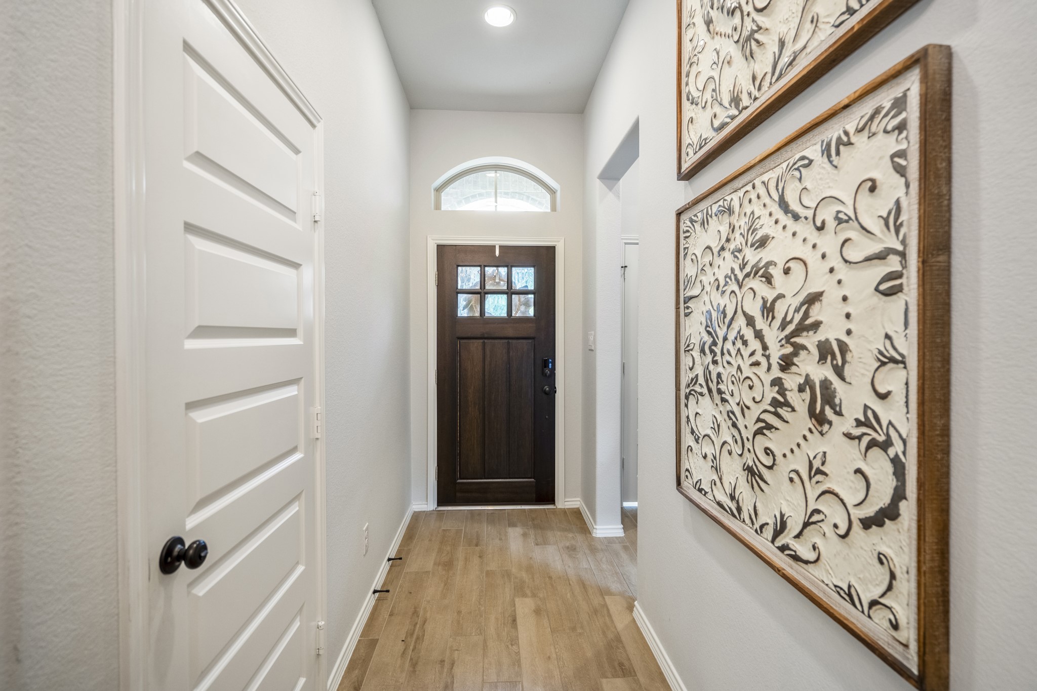 334 Topper Pines Drive Montgomery, TX 77316 - Photo 30 of 49 Coming back to the front hallway, the front door is straight ahead, the garage entry is on the left, and the alcove just off the entry comes into view on the right as the tour shifts back toward the laundry area.