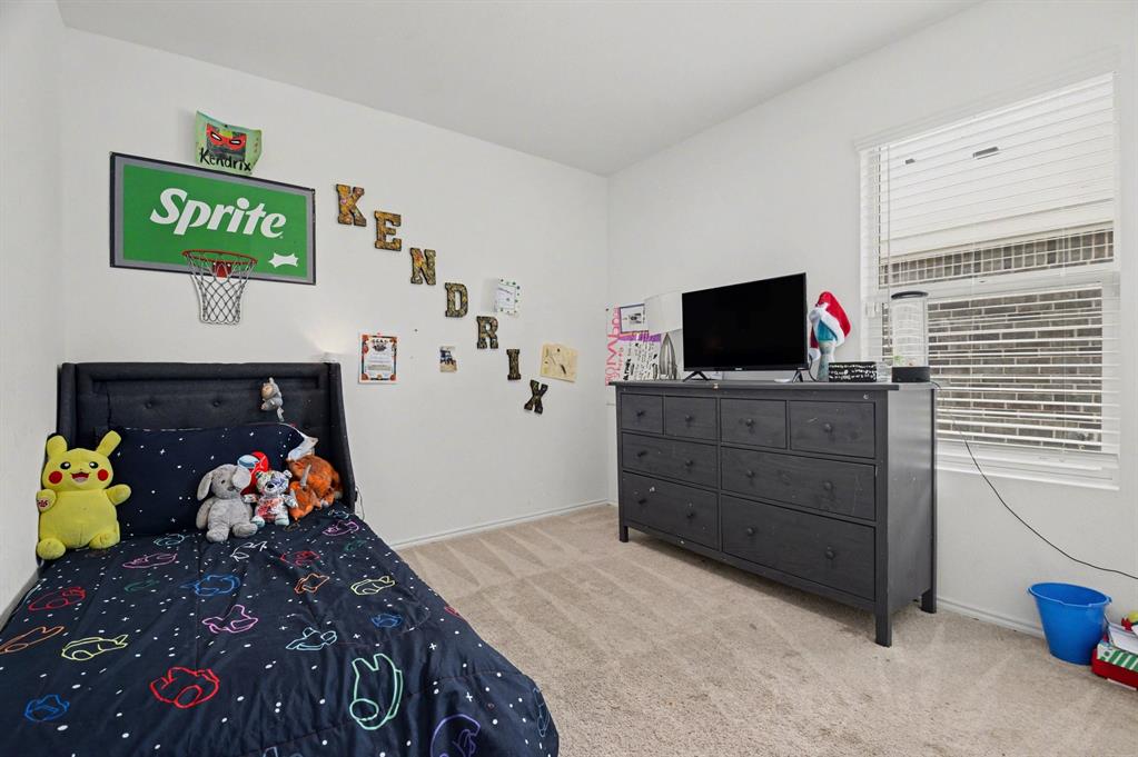 1711 High Perch Lane Forney, TX 75126 - Photo 12 of 16 a bedroom with a bed and wooden floor
