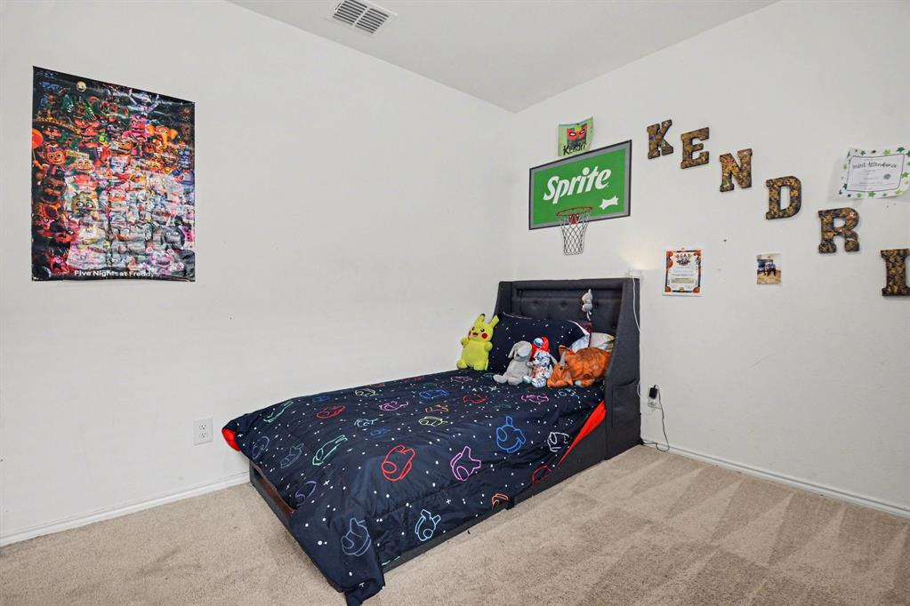 1711 High Perch Lane Forney, TX 75126 - Photo 13 of 16 a bed room with furniture and painting on the wall