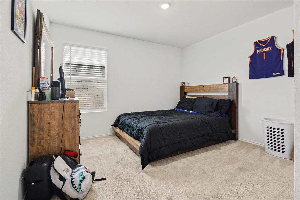 1711 High Perch Lane Forney, TX 75126 - Photo 14 of 16 a bedroom with a bed and a couch