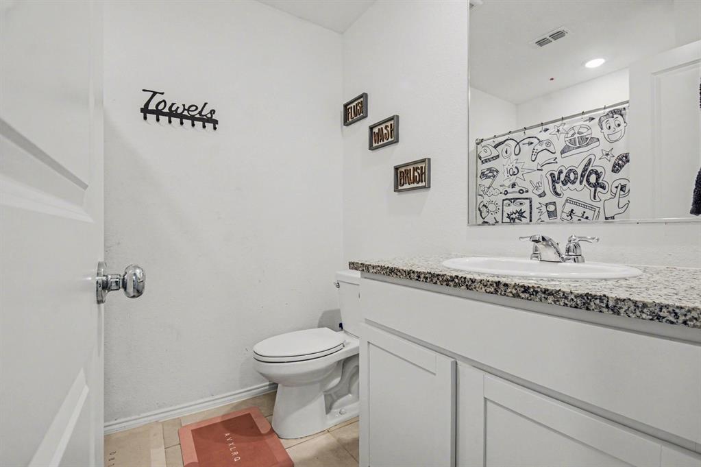 1711 High Perch Lane Forney, TX 75126 - Photo 15 of 16 a bathroom with a granite countertop sink a toilet and a shower