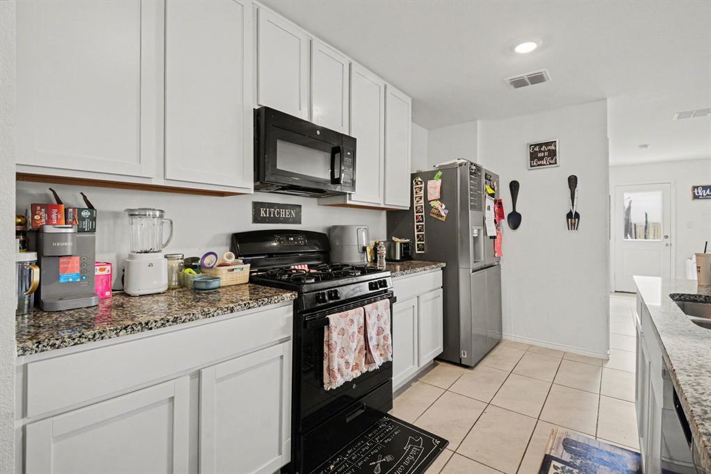 1711 High Perch Lane Forney, TX 75126 - Photo 5 of 16 a kitchen with stainless steel appliances granite countertop a refrigerator stove and sink