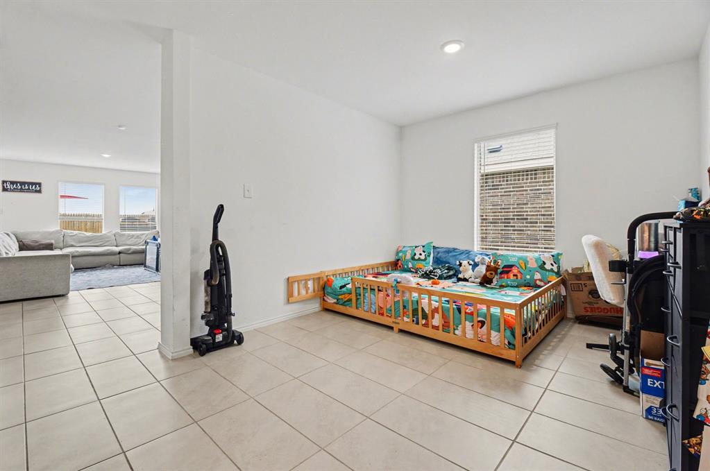 1711 High Perch Lane Forney, TX 75126 - Photo 6 of 16 a very nice looking room with a big bed and a window