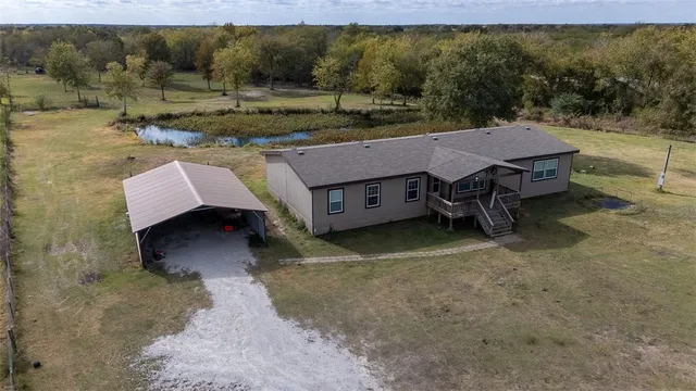 an aerial view of a house with a yard