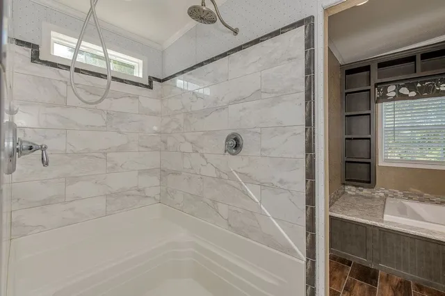 a view of an empty room with a fireplace and a window
