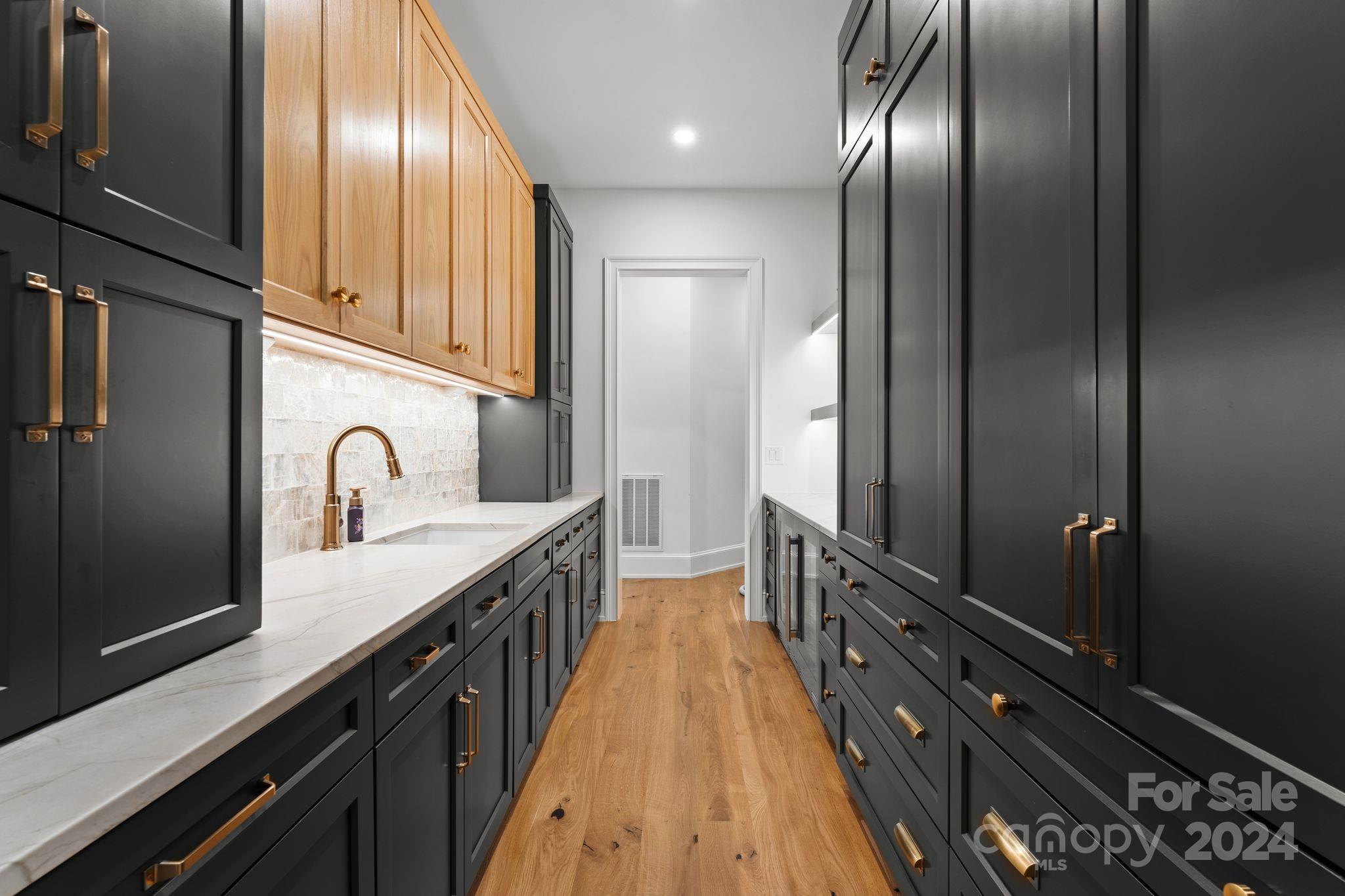 20218 Rainbow Circle Cornelius, NC 28031 - Photo 16 of 44 a kitchen with granite countertop stainless steel appliances a sink stove refrigerator and cabinets