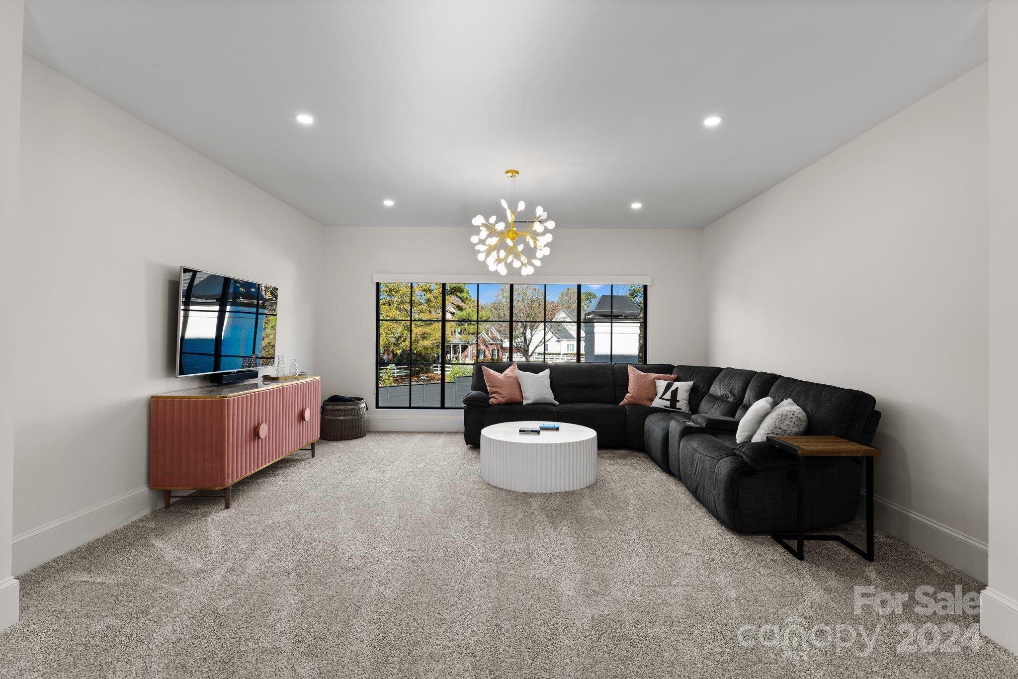 20218 Rainbow Circle Cornelius, NC 28031 - Photo 33 of 44 a living room with furniture and a chandelier