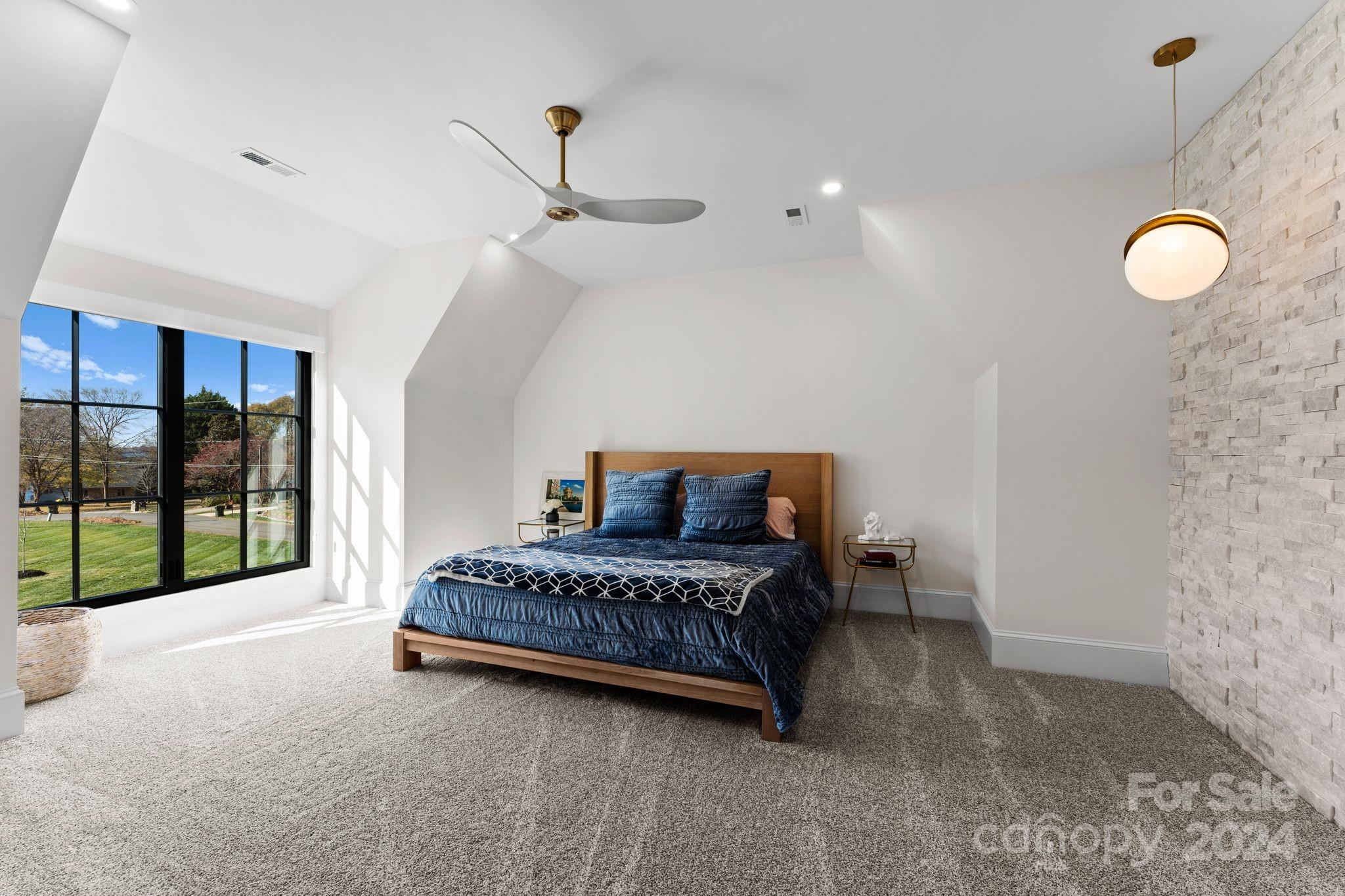 20218 Rainbow Circle Cornelius, NC 28031 - Photo 38 of 44 a spacious bedroom with a bed and large windows