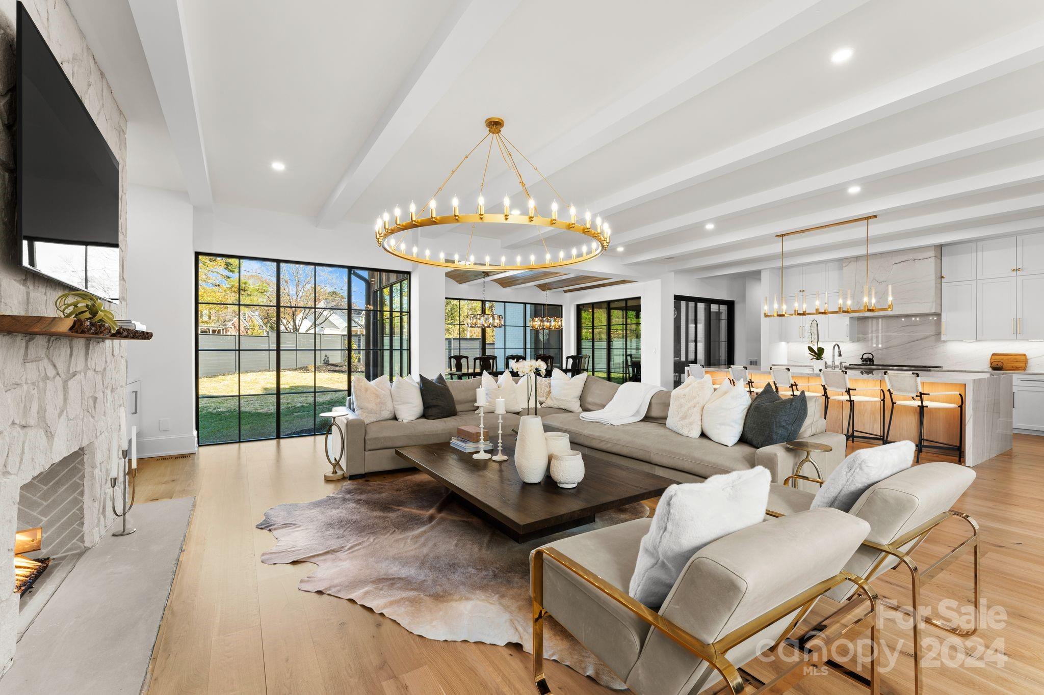 20218 Rainbow Circle Cornelius, NC 28031 - Photo 6 of 44 a living room with furniture fireplace and a flat screen tv