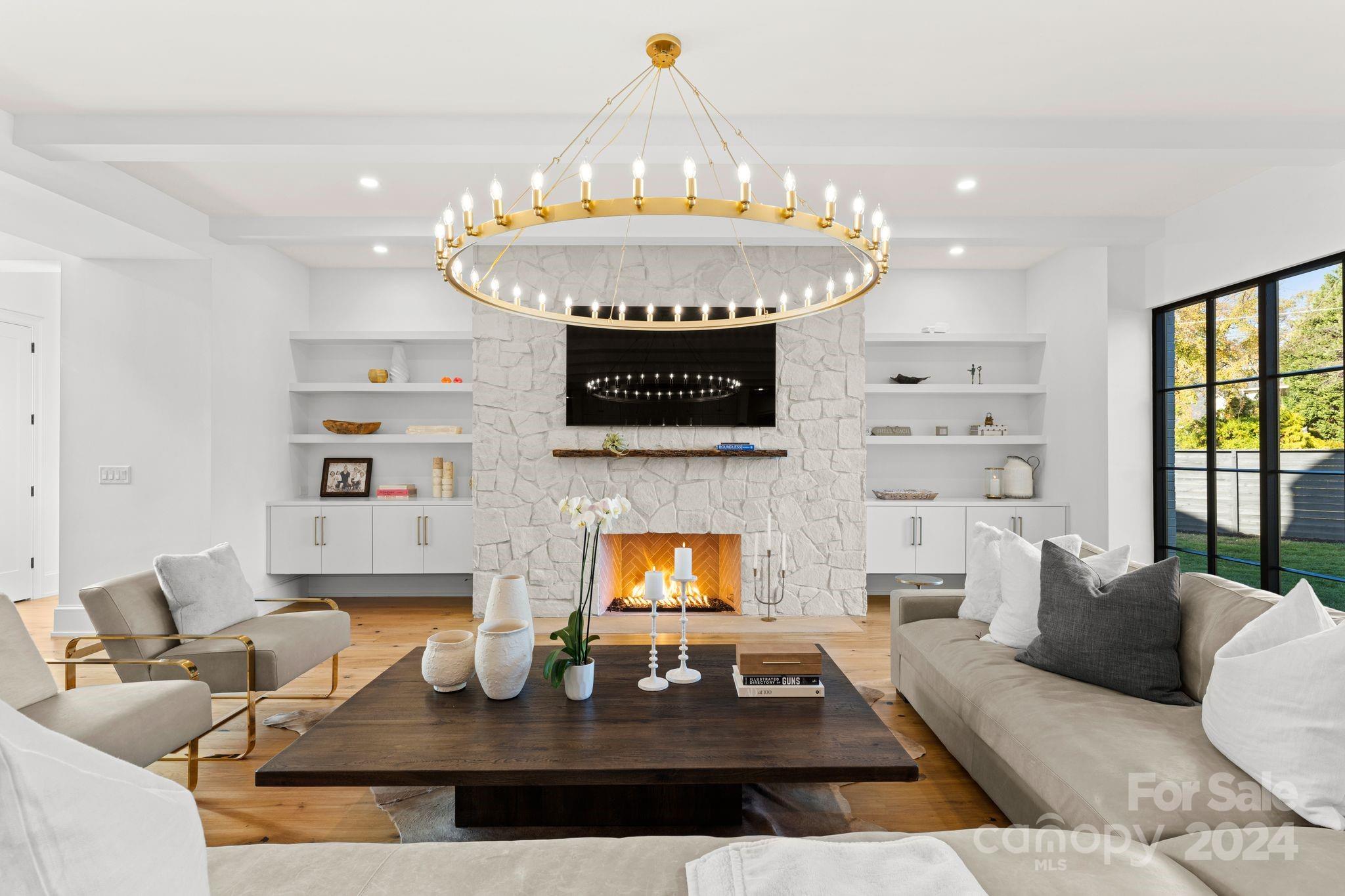 20218 Rainbow Circle Cornelius, NC 28031 - Photo 7 of 44 a living room with furniture a fireplace and a chandelier