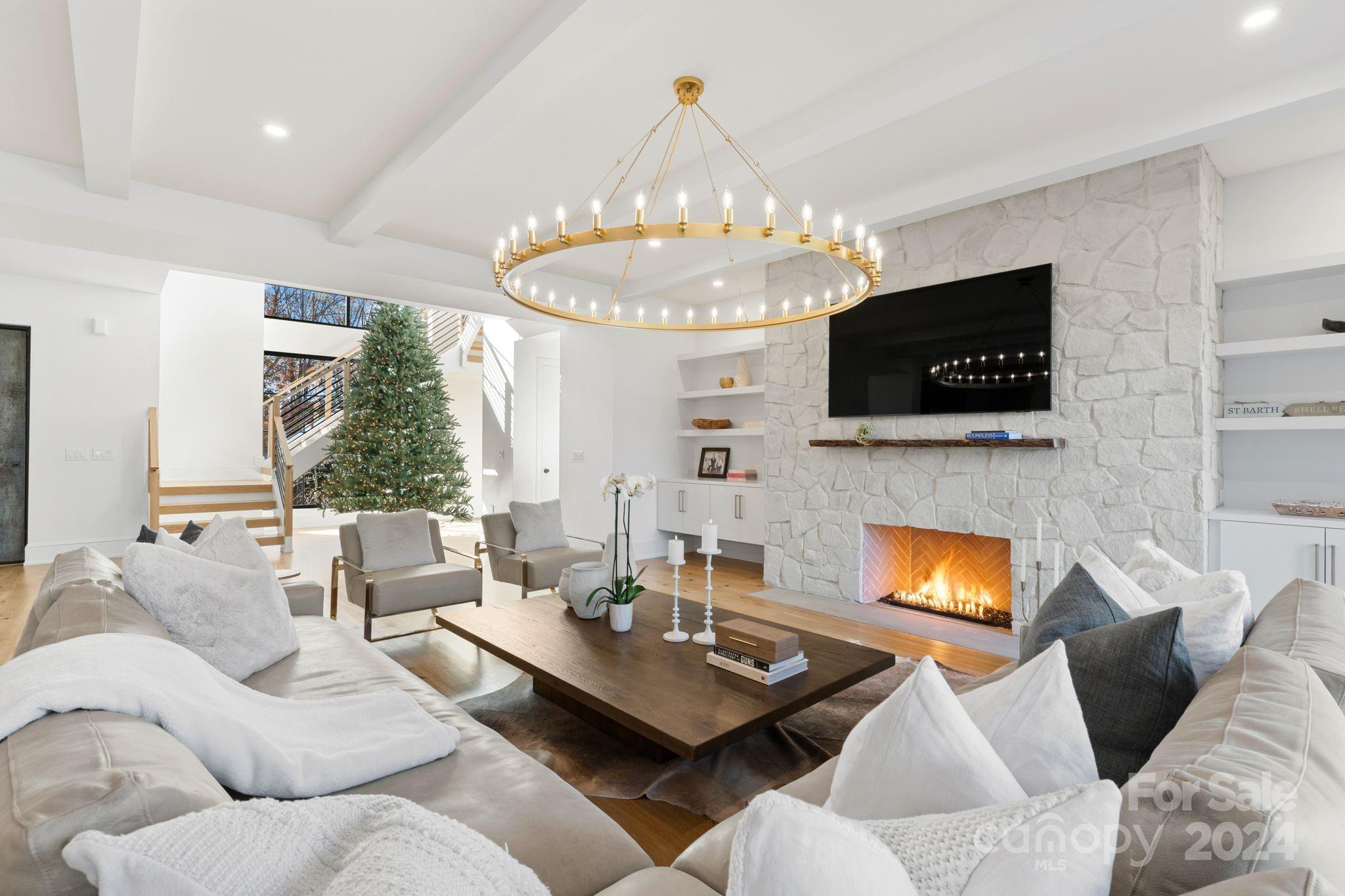 20218 Rainbow Circle Cornelius, NC 28031 - Photo 8 of 44 a living room with furniture a fireplace and a flat screen tv